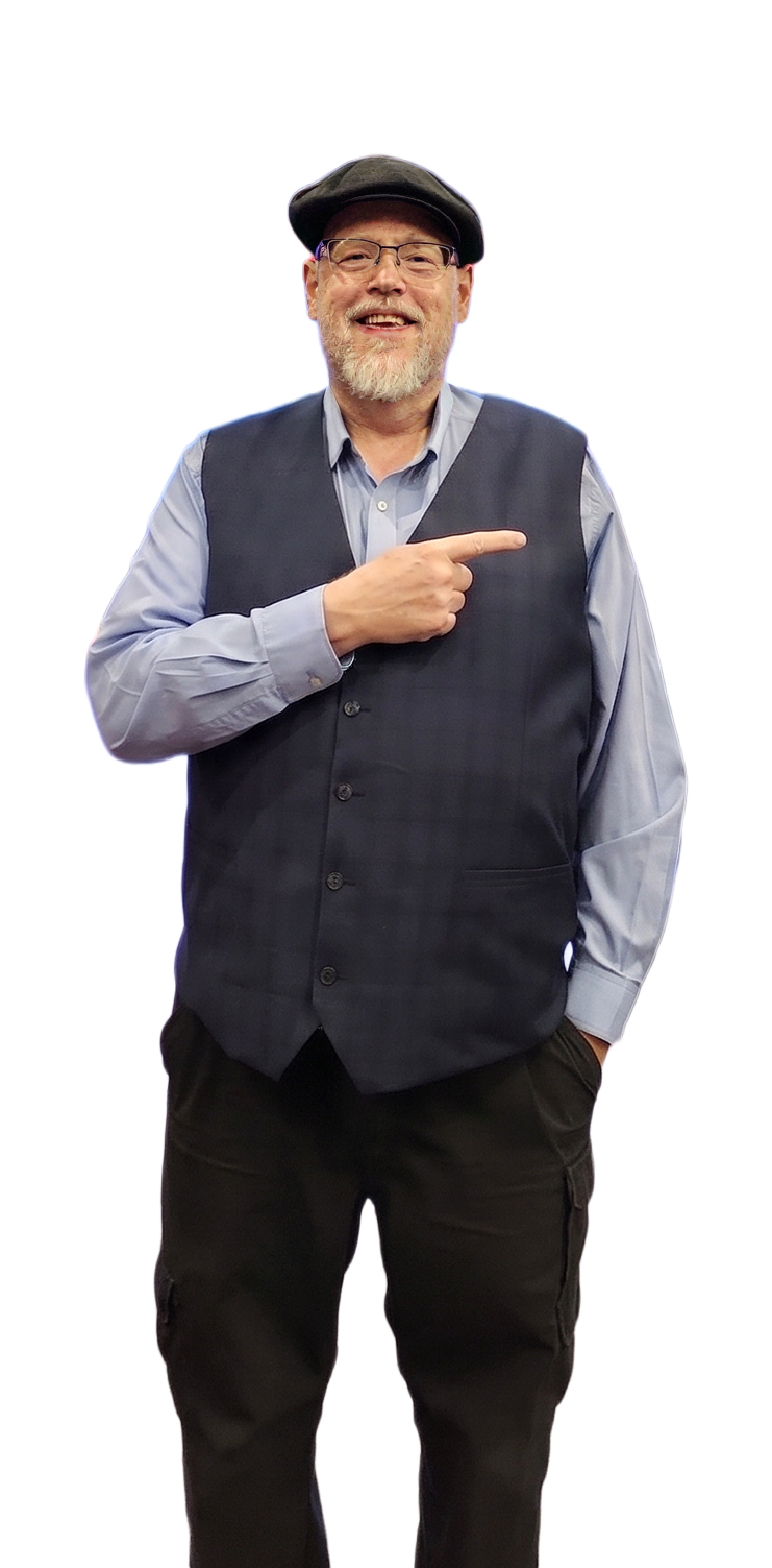 Ken Sapp smiling, wearing glasses, a flat cap, and a dark waistcoat